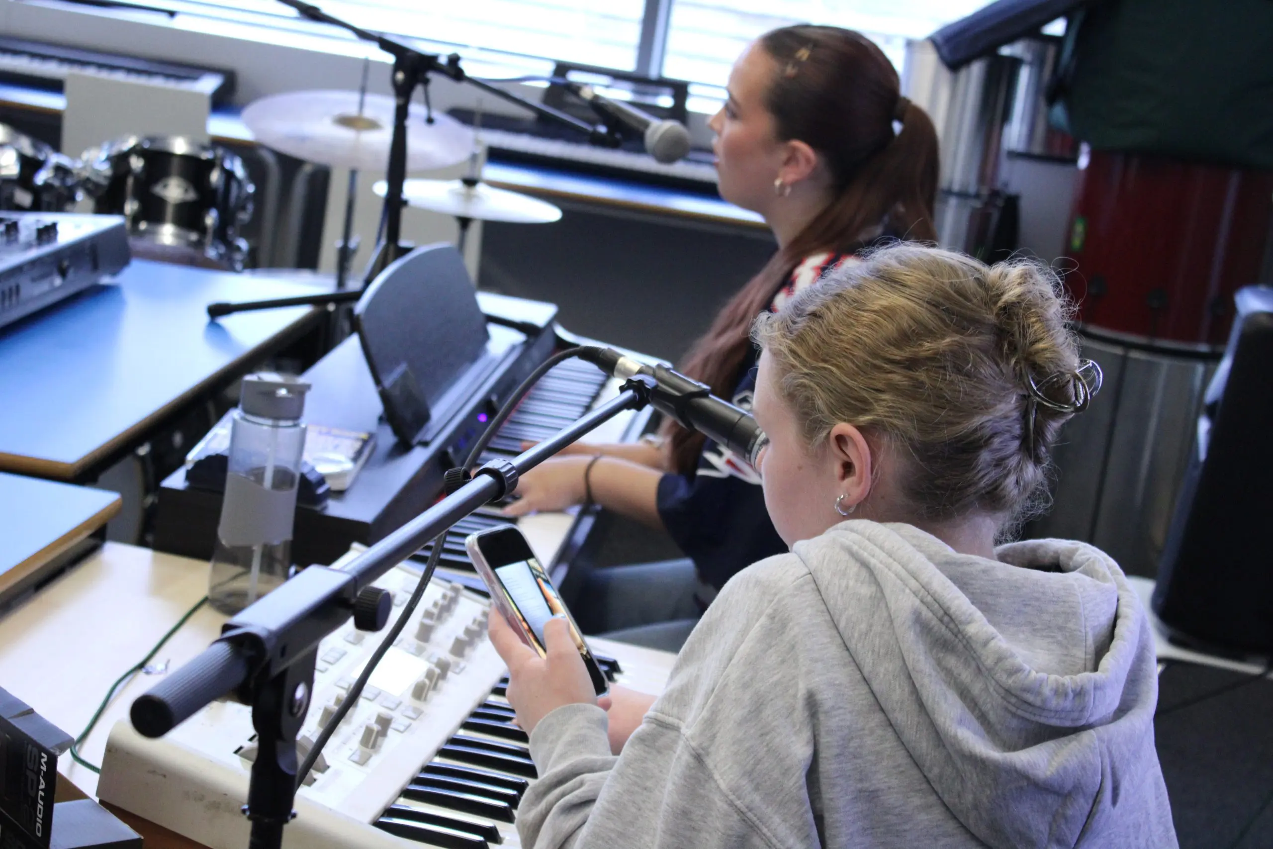 Young musicians singing and playing keyboards, producing music with the Folkestone Music Lab