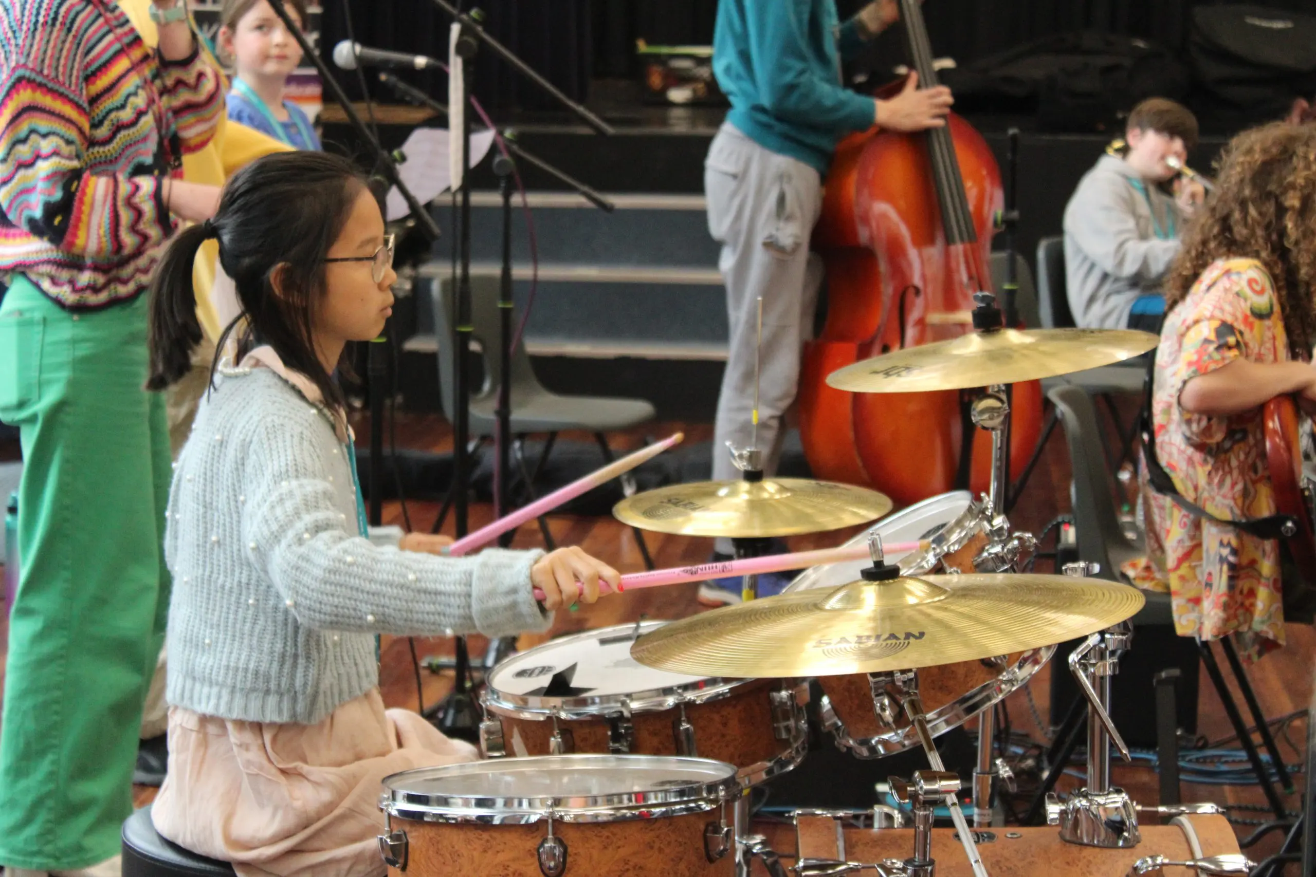 Girl playing the drums in Orchestra One music ensemble