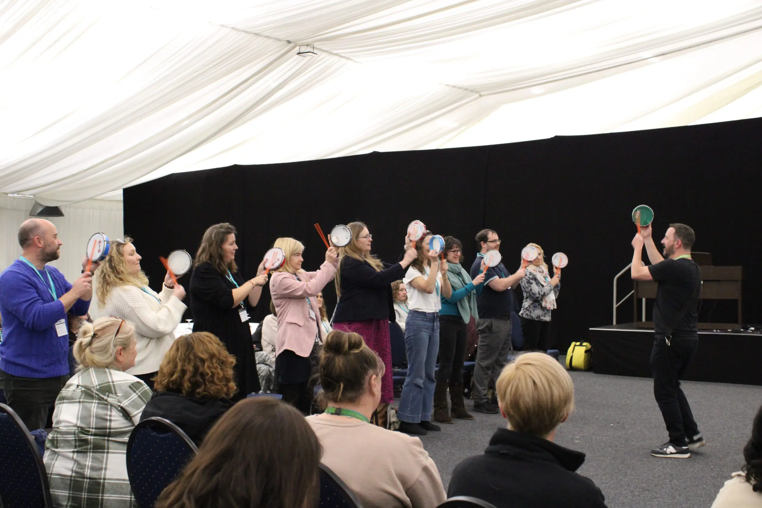 Teachers and staff getting involved playing drums in a workshop at the Kent and Medway Conference for Kent Music