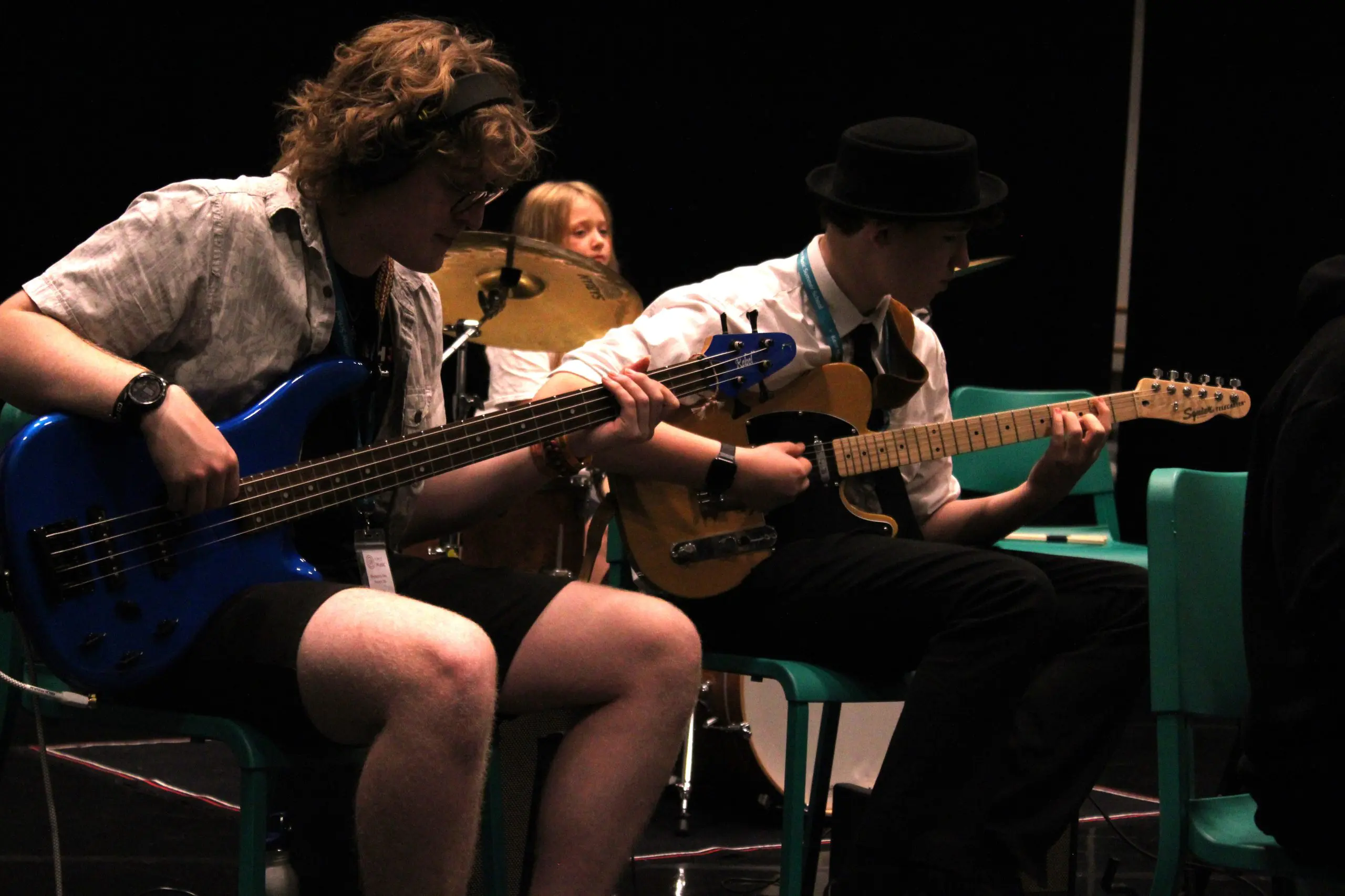 Young students playing the bass and electric guitar at Orchestra One course