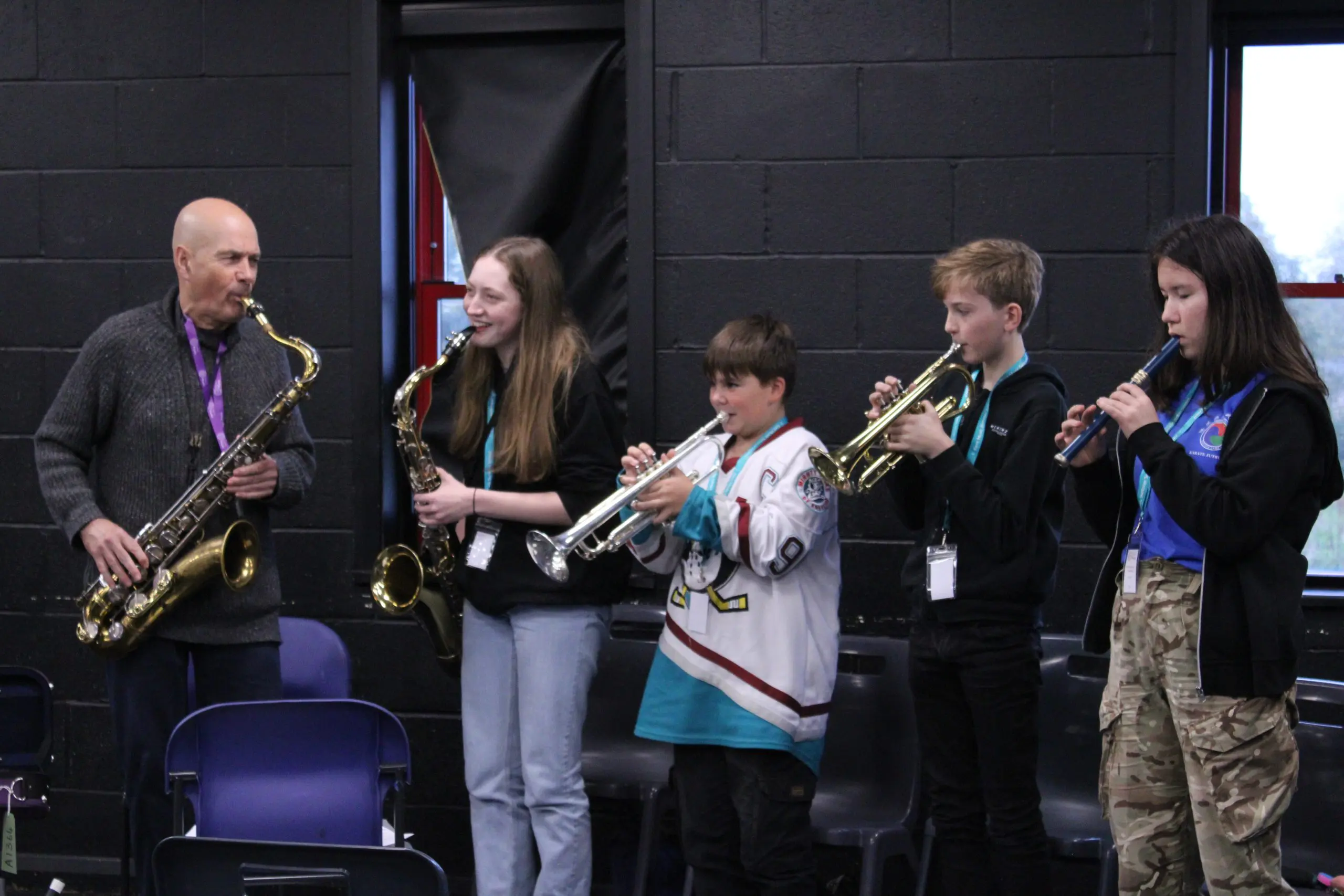 Students having fun playing musical instruments at Orchestra One course